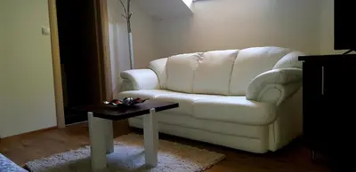 a living room with a white couch and a table at Apartman Campari in Banja Luka