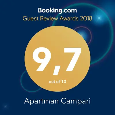 a sign that says quest review awards with a yellow circle at Apartman Campari in Banja Luka
