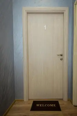 a door with a welcome mat in front of it at Apartman Campari in Banja Luka