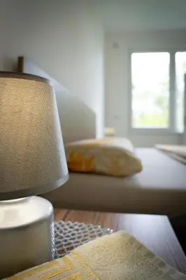 a bedroom with a bed and a table with a lamp at Apartment Una Laguna in Bihać