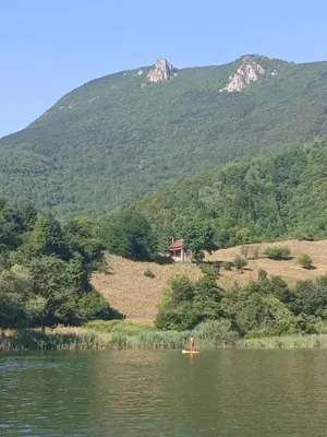 a person in a kayak in a lake with a mountain at Jovan in Šipovo