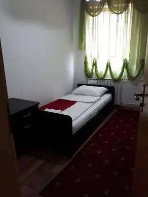 a small bedroom with a bed with a window at 