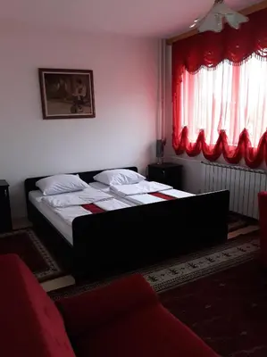 a bedroom with a bed and a red window at 