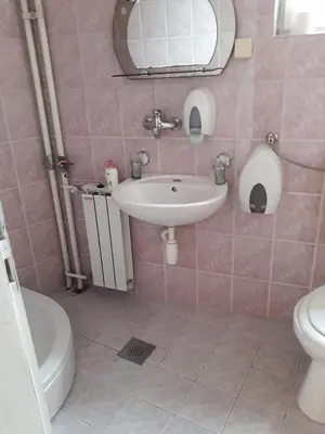 a bathroom with a sink and a toilet and a mirror at 