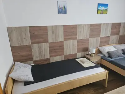 a bedroom with a bed and a wooden wall at Restoran i sobe 