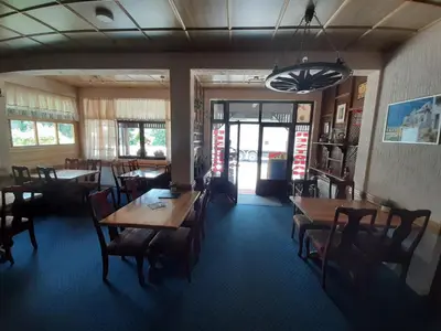 a dining room with tables and chairs in a restaurant at Restoran i sobe 