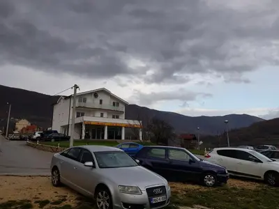 a group of cars parked in front of a building at Mediteran B&B in Prozor