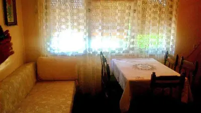 a room with a table and chairs and a window at Apartman Retro Una in Banja Luka