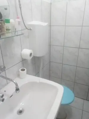 a bathroom with a white tub and a sink at Apartman Retro Una in Banja Luka
