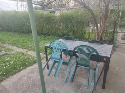 a wooden table with four chairs around it at Apartman Retro Una in Banja Luka