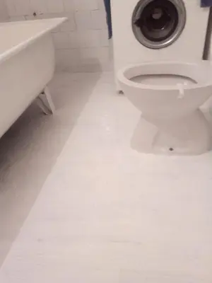 a white bathroom with a toilet and a sink at Apartman Retro Una in Banja Luka