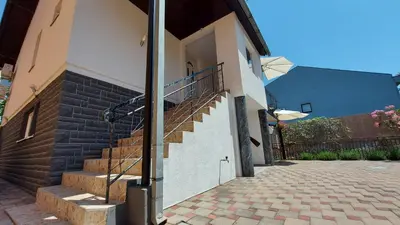 a house with stairs on the side of it at Apartment Kapetanovic in Bosanski Šamac