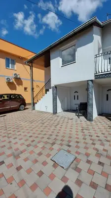 a house with a car parked in front of it at Apartment Kapetanovic in Bosanski Šamac
