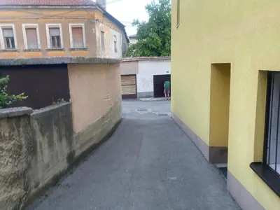 an alley between two buildings with a person walking down the street at Apartment Poturmahala in Travnik