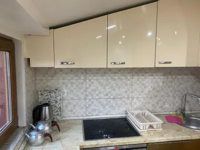 a kitchen with white cabinets and a sink at Apartment Poturmahala in Travnik