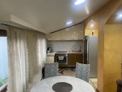 a kitchen with a table and a refrigerator at Apartment Poturmahala in Travnik