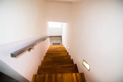a staircase in a building with wooden floors and white walls at Naid Apartmani in Kulen Vakuf