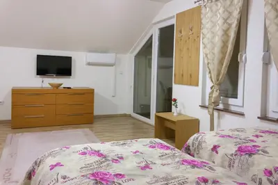 a bedroom with a bed and a tv on a dresser at Villa Maja in Bihać