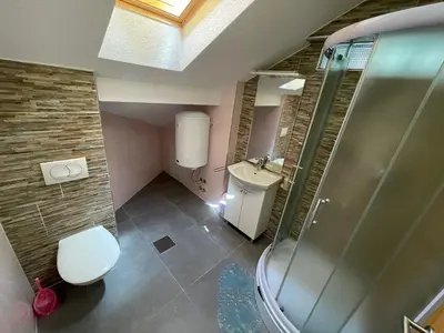 a bathroom with a shower and a toilet and a sink at Villa Maja in Bihać