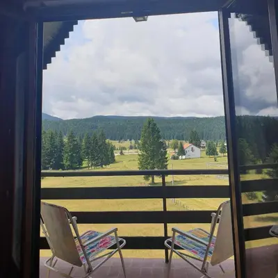 two chairs sitting on a porch with a view of a field at Green Forest in Vlasic