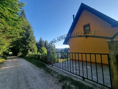 a fence in front of a building with a sign on it at Green Forest in Vlasic