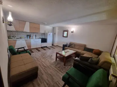 a living room with a couch and a table at Green Forest in Vlasic