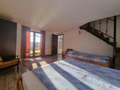 a bedroom with two beds and a staircase at Green Forest in Vlasic