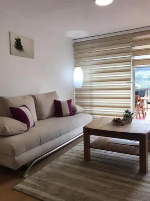 a living room with a couch and a coffee table at Ammirevole -MOON- Apartment in Visoko