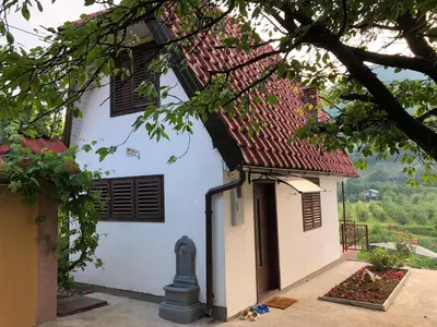 a white house with a red roof at Ammirevole -MOON- Apartment in Visoko