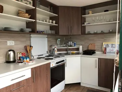 a kitchen with white appliances and wooden cabinets at Ammirevole -MOON- Apartment in Visoko