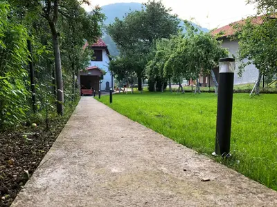 a sidewalk in a park with a black pole at Ammirevole -MOON- Apartment in Visoko