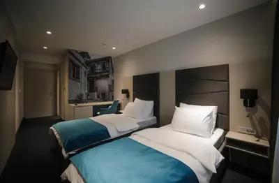 a hotel room with two beds in a room at Hotel Bank in Kiseljak