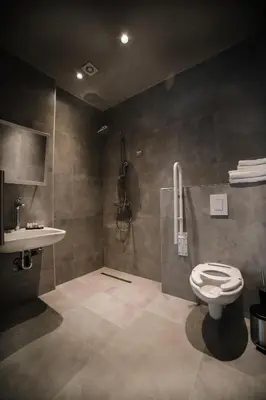 a bathroom with a toilet and a sink at Hotel Bank in Kiseljak