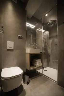 a bathroom with a shower and a toilet and a sink at Hotel Bank in Kiseljak