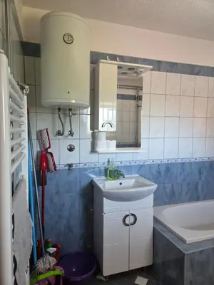 a bathroom with a sink and a tub and a mirror at Biser-Hatinac in Bihać