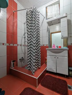 a bathroom with a shower and a sink and a mirror at Apartment LAMI - Kalibunar, Travnik in Travnik