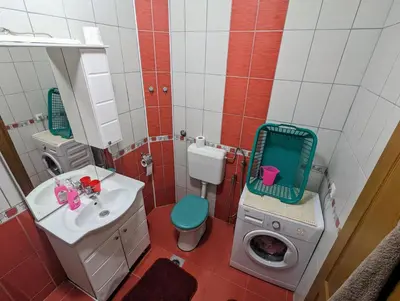 a bathroom with a toilet sink and a washing machine at Apartment LAMI - Kalibunar, Travnik in Travnik