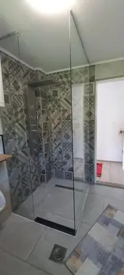 a shower in a room with a glass wall at Apartment 