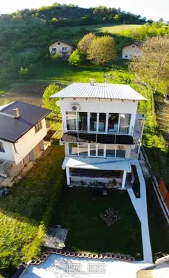 an aerial view of a white house with a yard at Apartment 