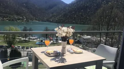 a table with a vase of flowers on a balcony at Apartment 
