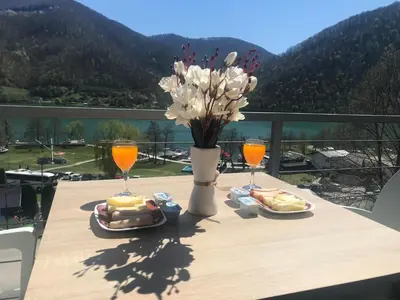 a table with two plates of food and two glasses of orange juice at Apartment 