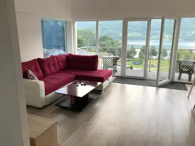 a living room with a red couch and a table at Apartment 