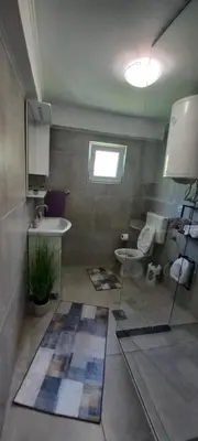 a bathroom with a sink and a toilet at Apartment 
