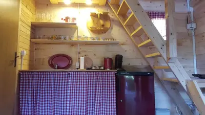 a kitchen with a ladder and a refrigerator in a room at Vacation home SAJRA in Kulen Vakuf