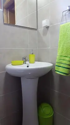 a bathroom with a sink and a green towel at Vacation home SAJRA in Kulen Vakuf
