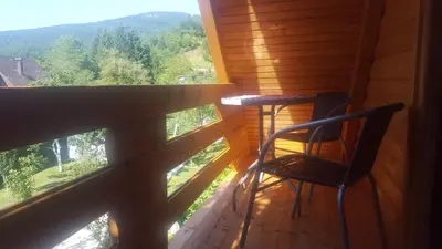 a chair on a porch with a view of the mountains at Vacation home SAJRA in Kulen Vakuf