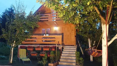 a wooden house with stairs leading up to it at Vacation home SAJRA in Kulen Vakuf
