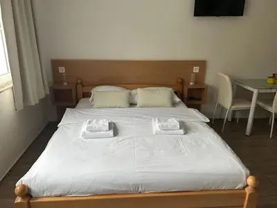 a bedroom with a bed with two towels on it at Apartmani Waterfall / Vodopad in Jajce