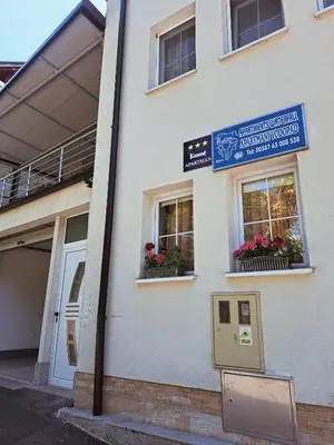 a building with two windows with flower boxes on it at Apartmani Waterfall / Vodopad in Jajce