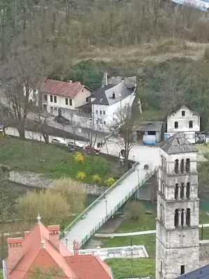 a small town with a bridge over a river at Apartmani Waterfall / Vodopad in Jajce